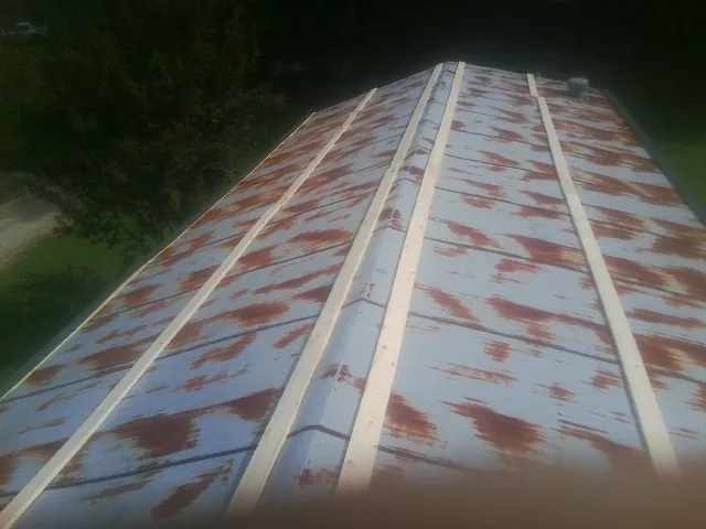 Rusted metal roof panels with new wood purlins before replacement — Storm Damage Roof Repair in Dingle by Roofing Brothers